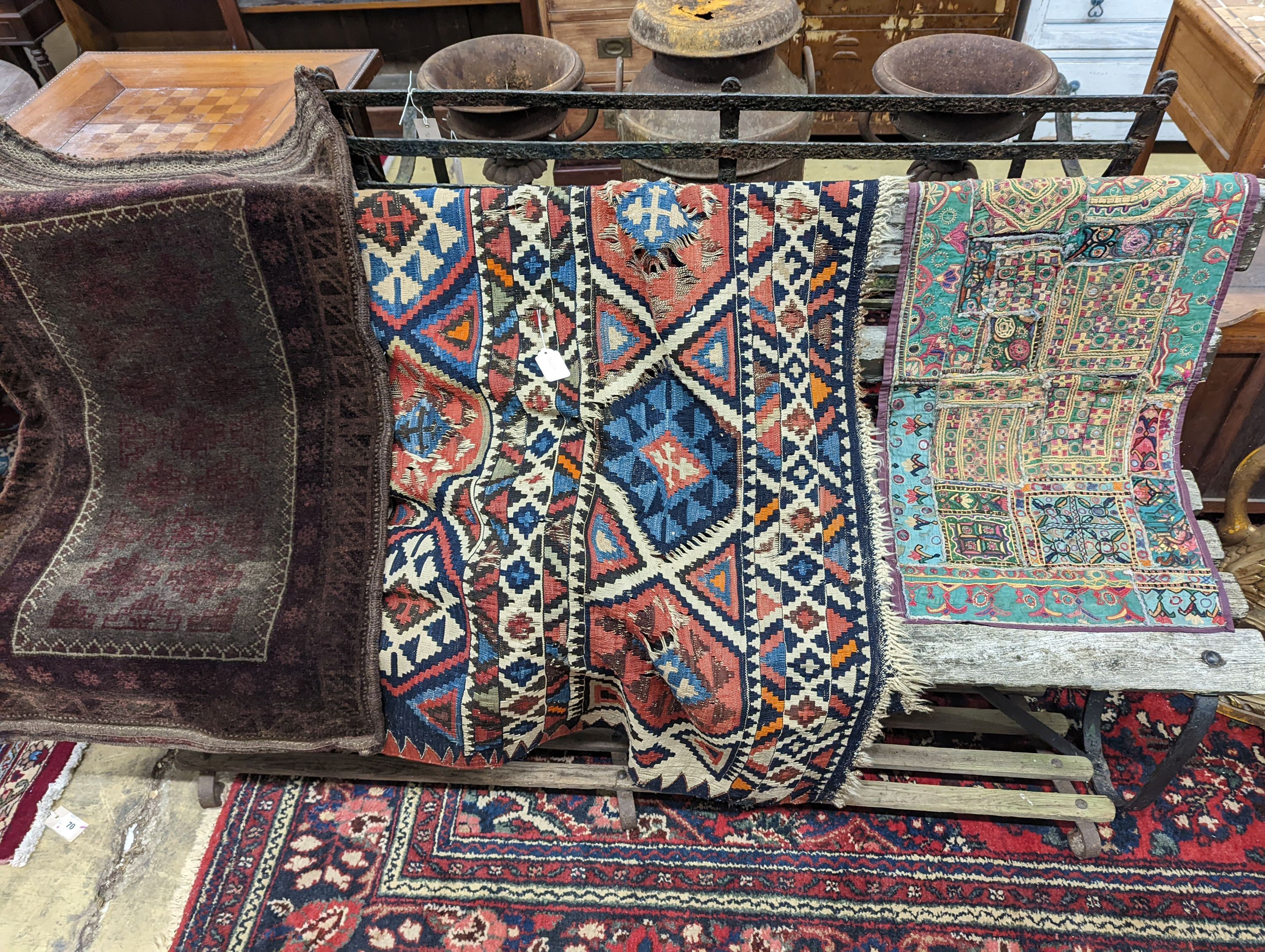 A Kelim flatweave rug, an Indian fabric panel and a saddle bag
